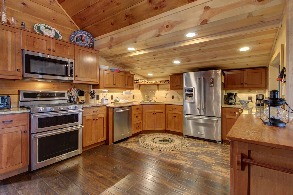 Photo of the kitchen at Star Vista, with wood paneling and all new appliances.