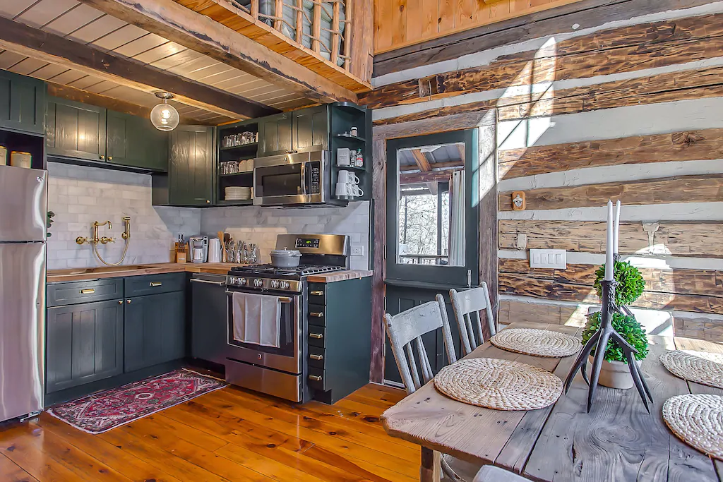 kitchen of cabin with log walls and wood floor