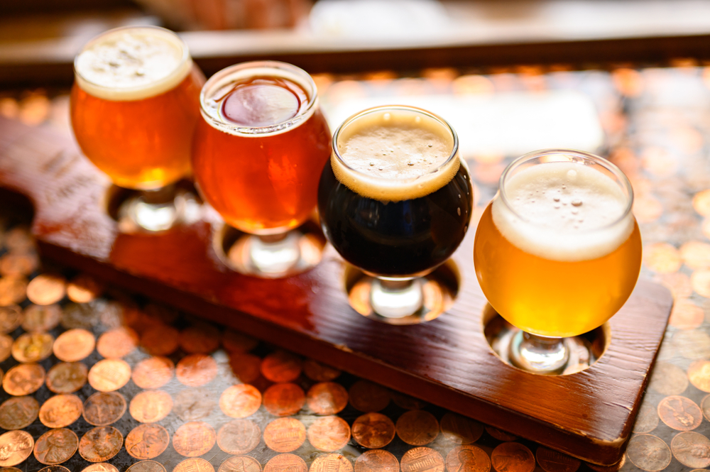 four beers on a flight tray