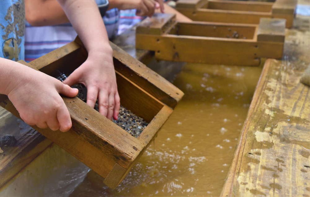 Miners at Cherokee Ruby and Sapphire Mine use screen boxes to clean gems, one of the best things to do in Franklin, NC