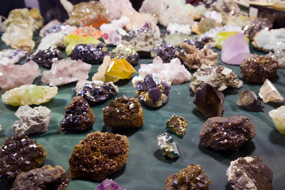 multi-colored gems and minerals on a table at the gem and mineral museum, one of the best things to do in Franklin, NC