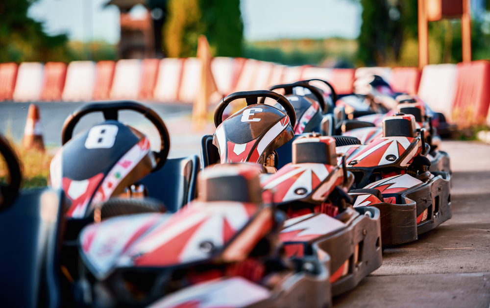 line of red go karts on a track at the factory