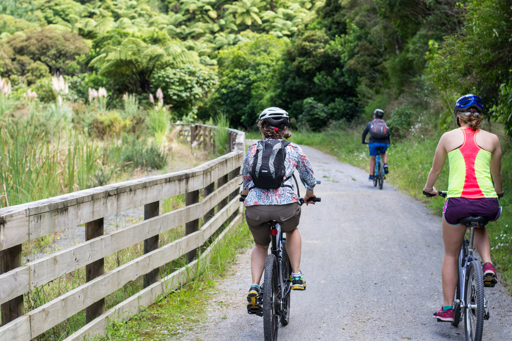 three bikers on the little Tennessee river greenway, one of the best things to do in Franklin, NC