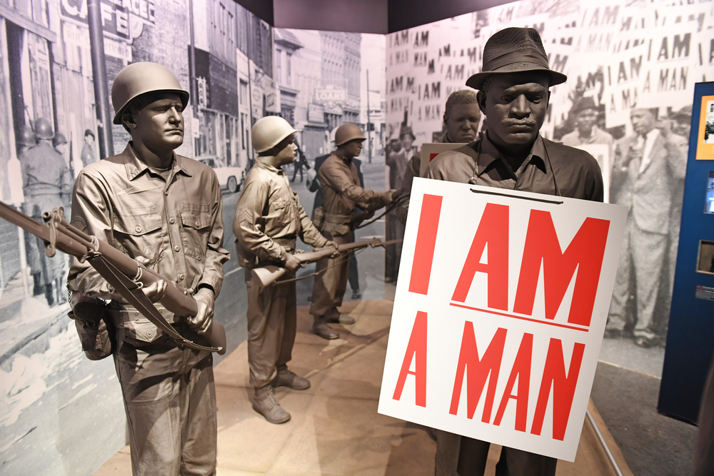 A Civil Rights exhibit similar to one you would see at the Civil Rights Museum located in Savannah. It is statues of men protesting with signs surrounded by military officers with guns. 