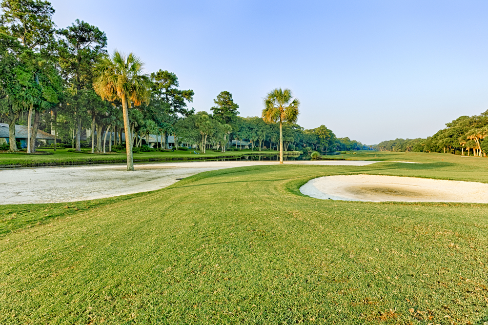 A large and very green golf course with palm trees, one of the best things to do in Hilton Head. 