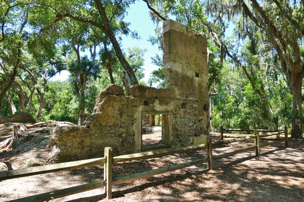 A view of the Stoney-Baynard Plantation Ruins. They are fenced off to protect them and are surrounded by trees. Its one of the best things to do in Hilton Head. 