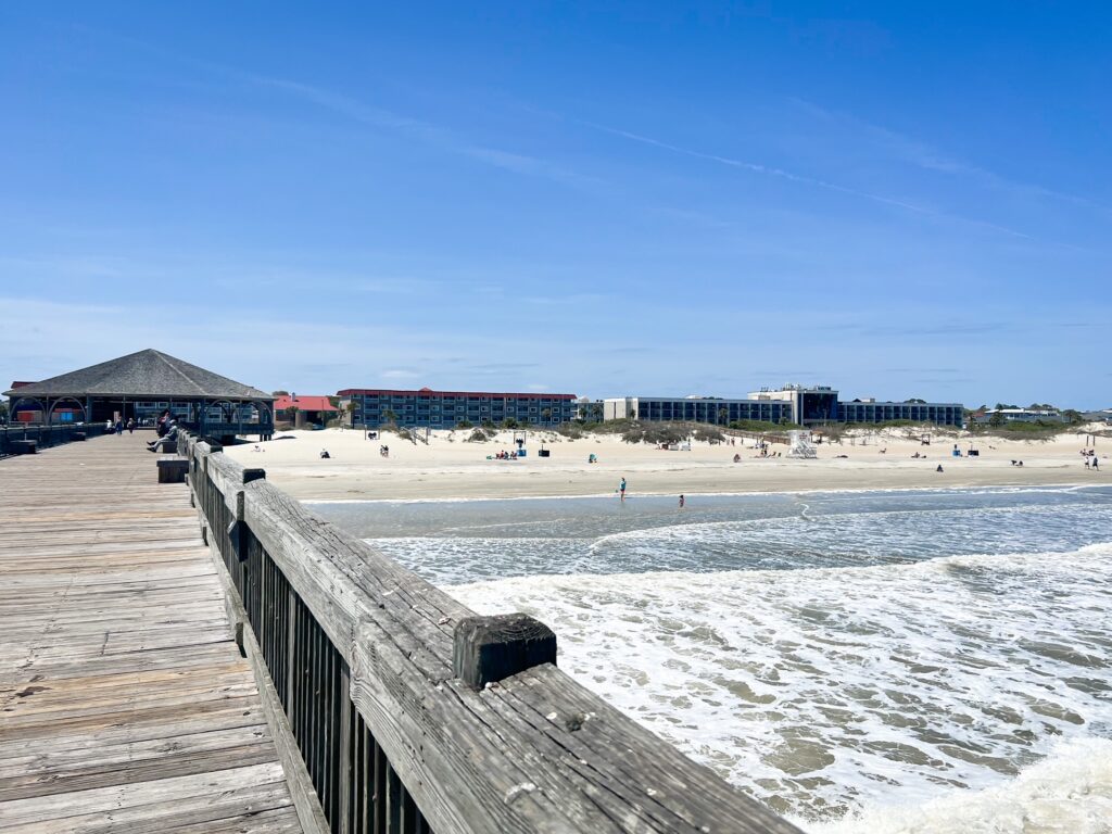 View of Tybee Island from the pier showing the beach and buildings. 