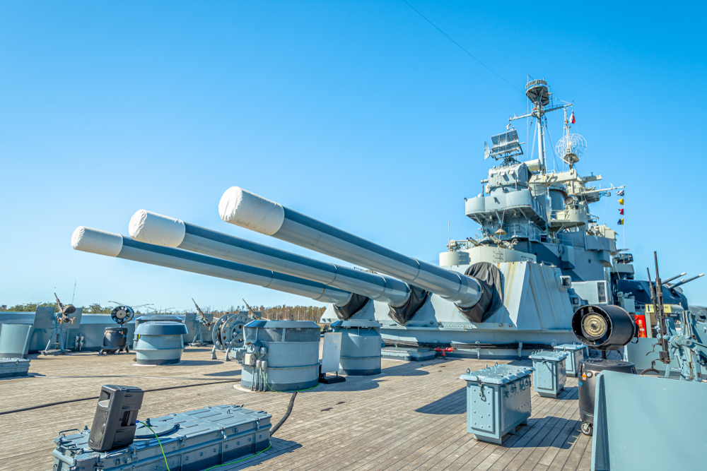 Main Gun on USS North Carolina Battleship under blue sky background.