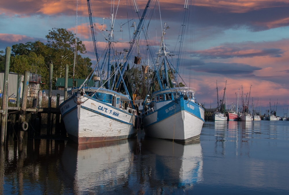 Two moored fishing boats at sunset in Darien, one of the loveliest beach towns in Georgia. 