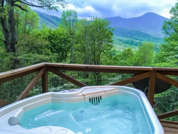 hot tub on the porch in one of the best cabins in asheville NC