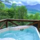 hot tub on the porch in one of the best cabins in asheville NC