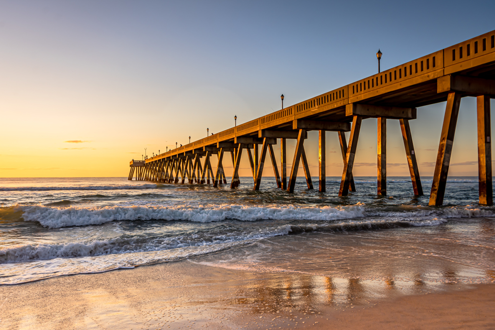 A long Fishing Pier at sunrise in Wrightsville Beach One of the best things to do in Wilmington NC.