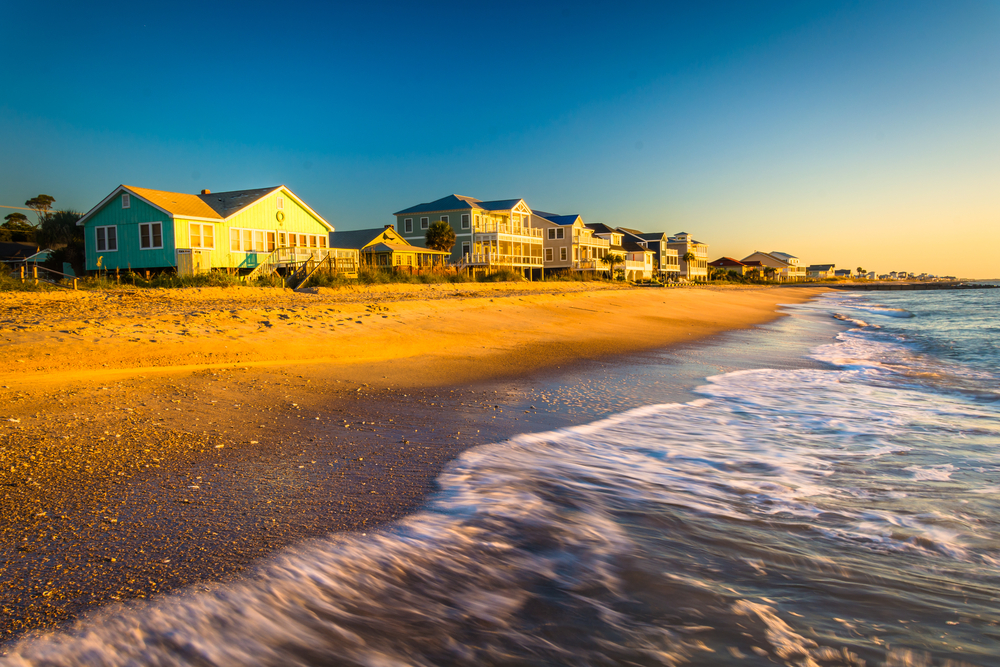At Eidsto beach, one of the beach towns in South Carolina, the historic homes sit on the shore during the golden hour, as waves crash quickly during high tide.