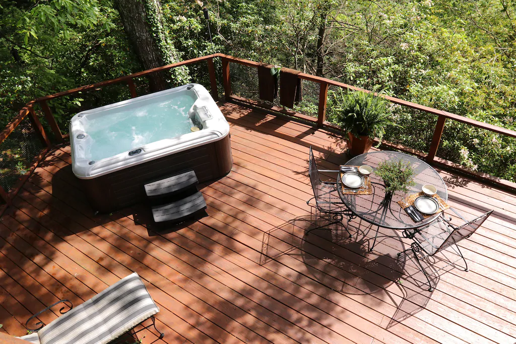 photo of deck with furniture and hot tub