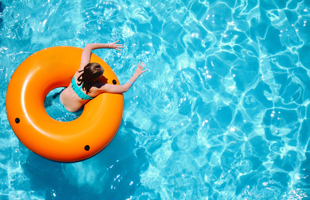woman floating in blue waters with orange tube at the best water parks in Tennessee