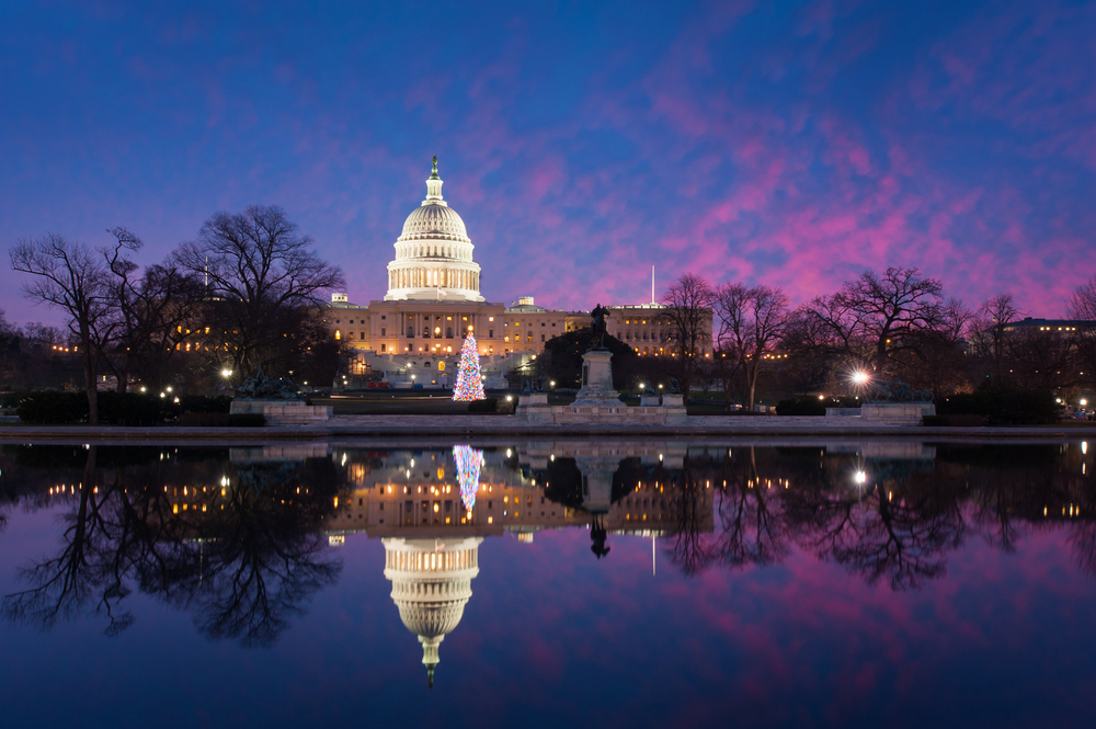 The Capitol Building lit up with a tree out front during Christmas in Washington DC at twilight