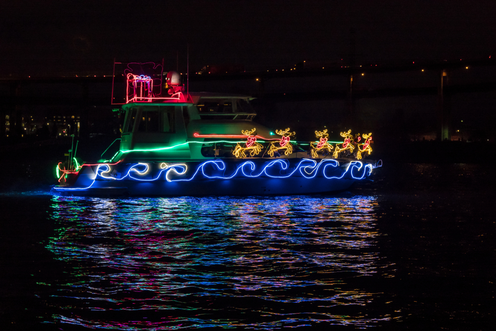 A boat covered in Christmas lights participating in a parade for Christmas in Washington DC