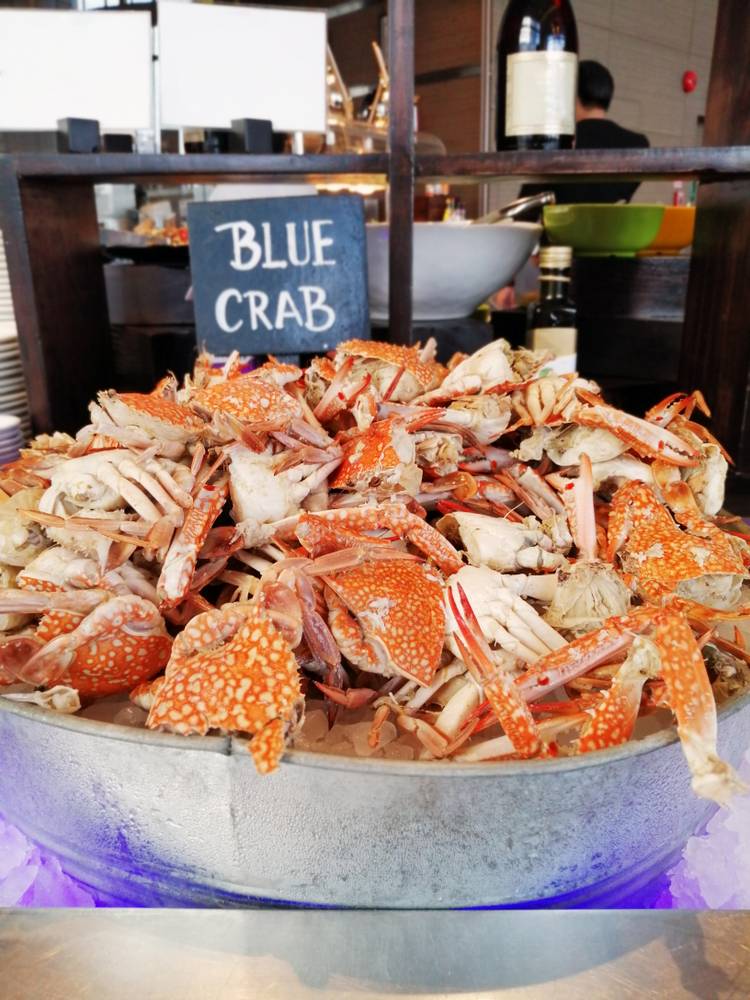 a large bucket of steamed blue crabs at the crab shack