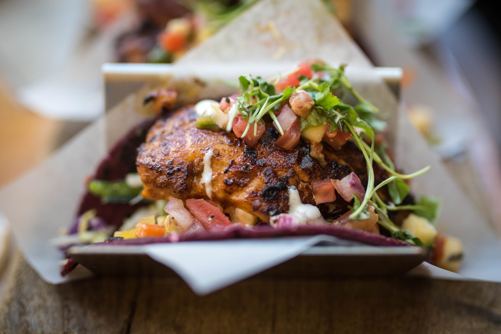 a blackened fish taco topped with fresh salsa