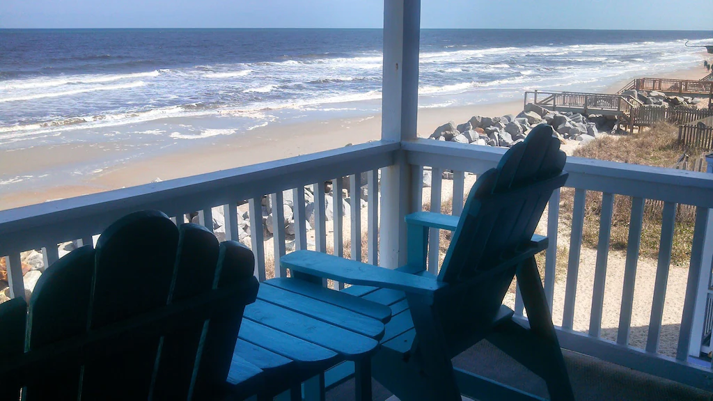 chairs on balcony overlooking ocean