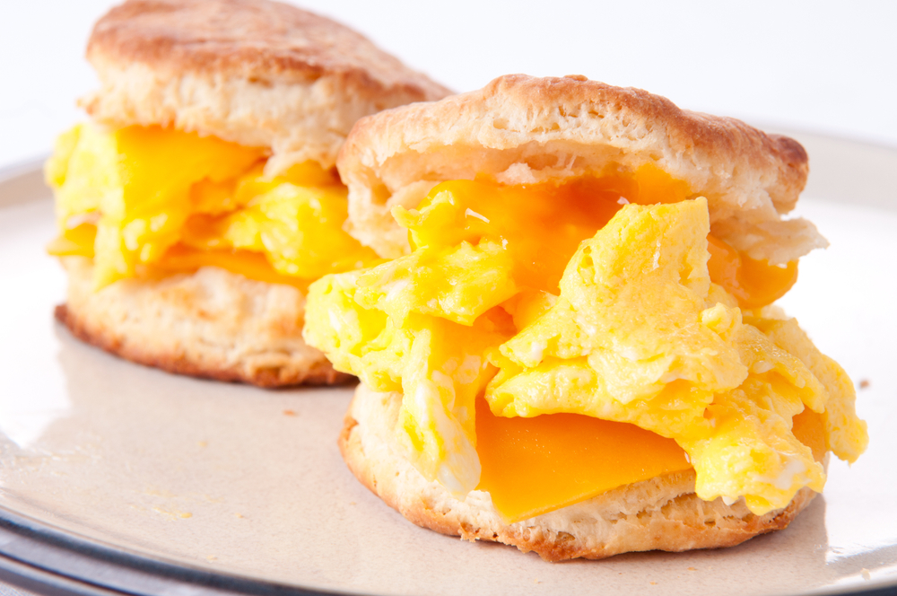 Close up photo of two biscuits with cheese and scrambled eggs, a dish served at the Old Chickahominy House, an iconic spot for breakfast in Williamsburg VA.