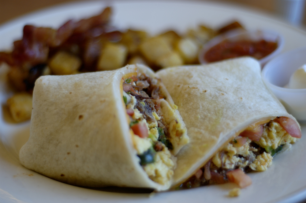 Close up of a breakfast burrito with home fries, which is one of our favourite options at Shorty's Diner, one of the best brunch spots in Williamsburg Virginia. 