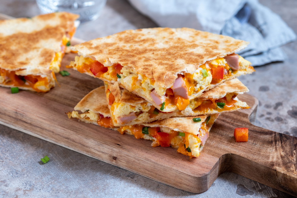 Breakfast quesadilla on a wooden serving board