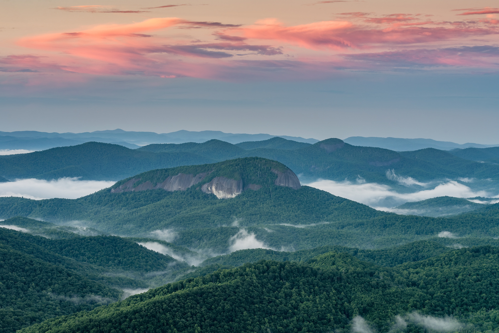 Pastel skies over foggy Looking Glass Rock as seen from Pounding Mill Overlook.
