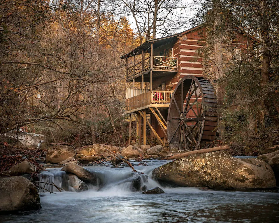 a rushing stream is a great addition to this rustic cabin in the woods on our list of the best cabin in the smoky mountains