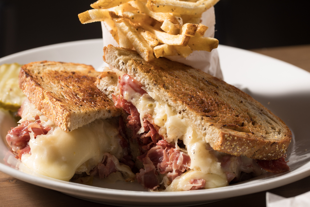 rueben and french fries on plate