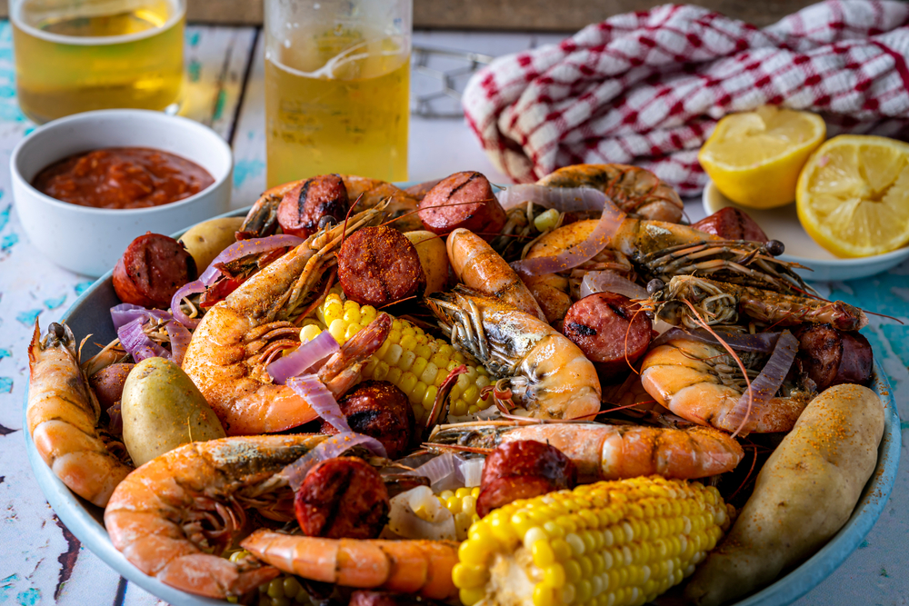 corn, sausage, other veggies and seafood in bowl on table