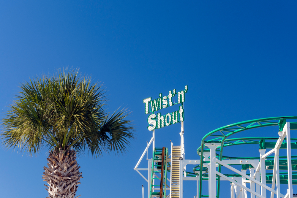 Family Kingdom Amusement Park, Twist 'n' Shout roller coaster amusement park ride. You can see the ride name some of the ride and palm trees. Its one of the best tthings to do at Myrtle Beach 