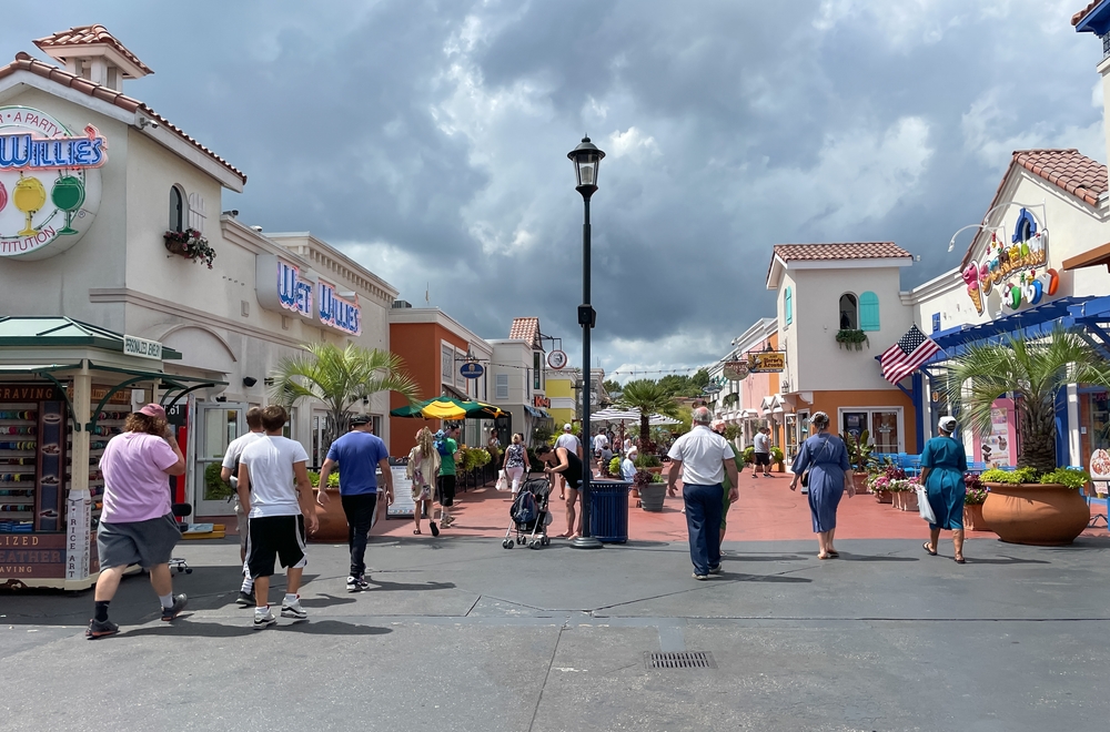 Roadside view of Broadway at the Beach shopping center with visitors passing in Myrtle Beach