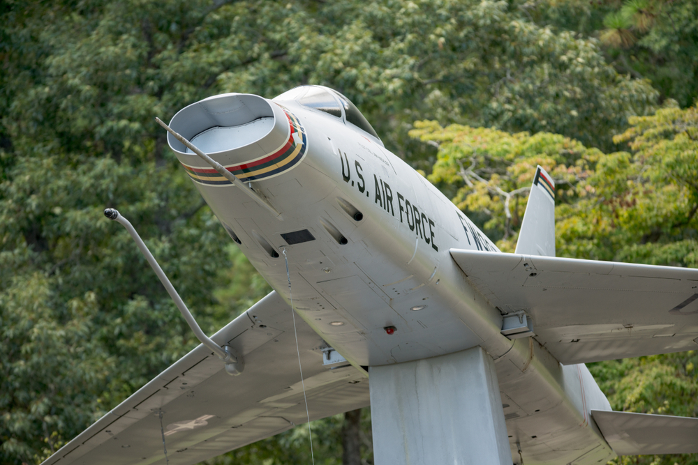 A US Air Force plane in Warbird Park. Trees are in the background. 
