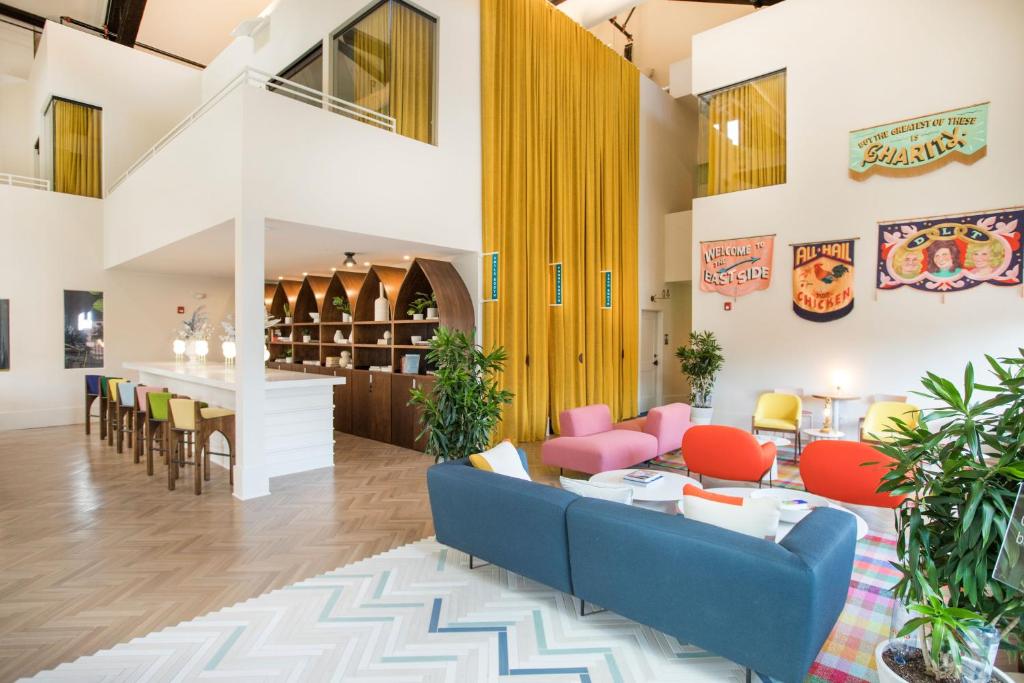 A double height hotel lobby with colorful furniture. 