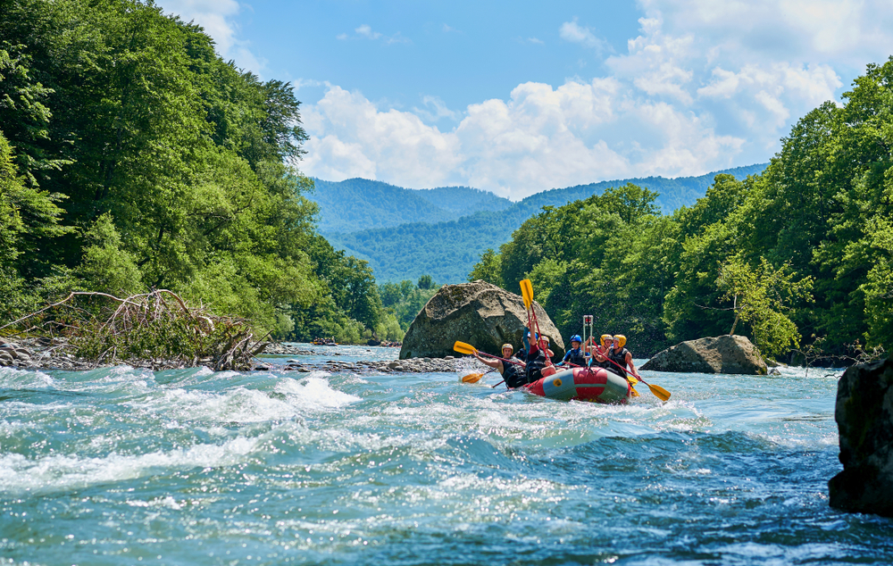 rafting down river in mountains