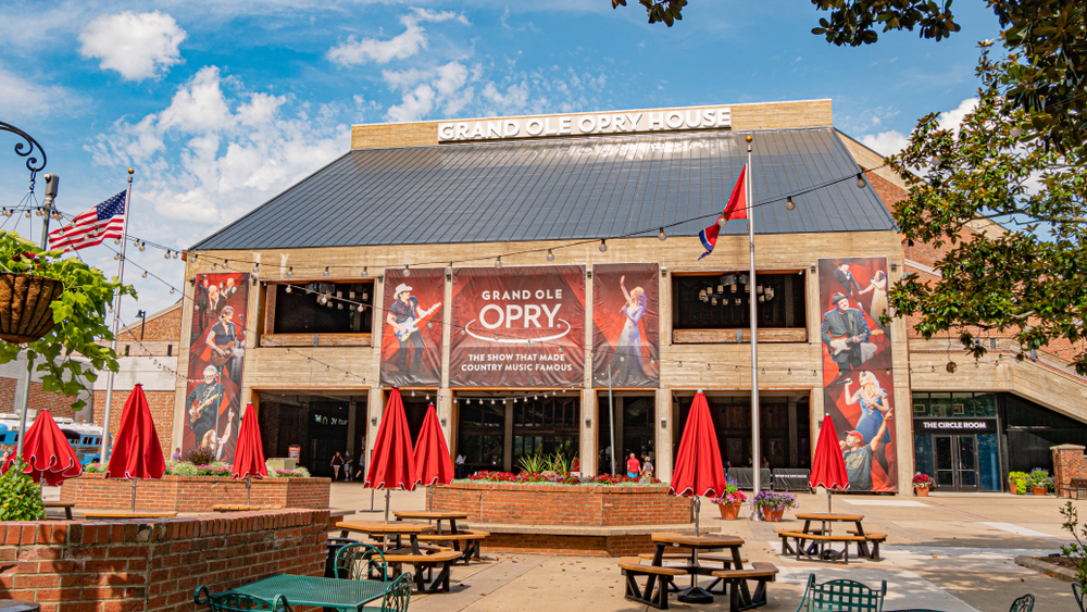 The front of the Grand Ole Opry building and picnic area on a sunny day. 