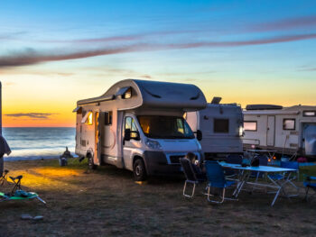 Photo of RVs on the beach during sunset at North Beach Campground, one of the best Outer Banks Campgrounds