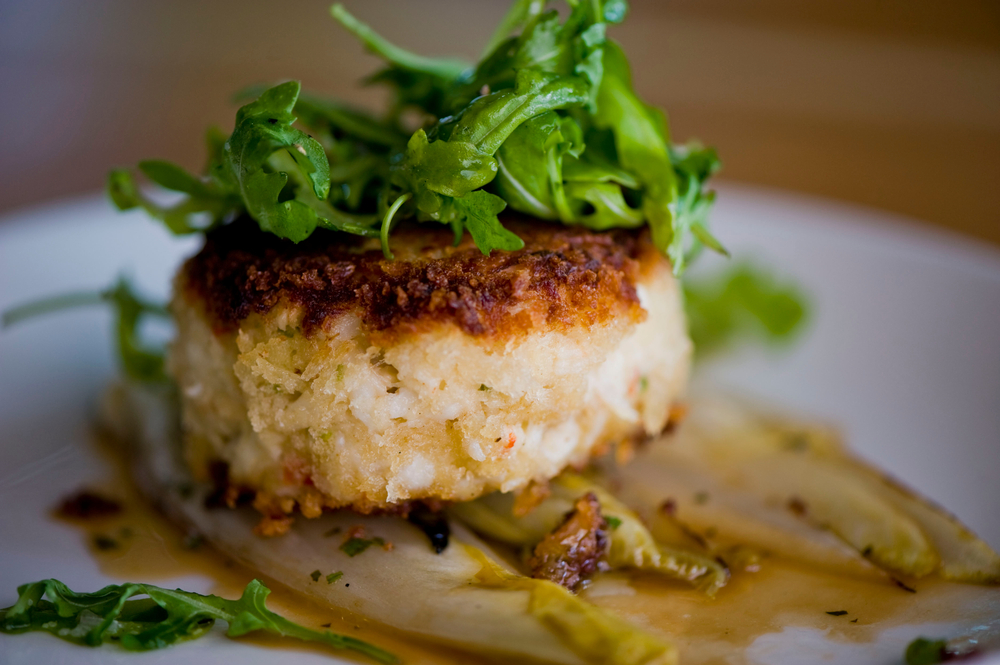 a crab cake  toepped with greens