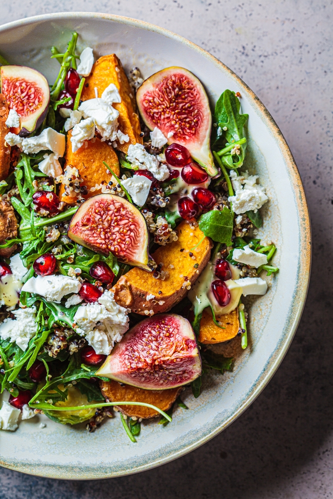 a salad with figs, sweet potatoes, goats cheese and pomagrantte seeds