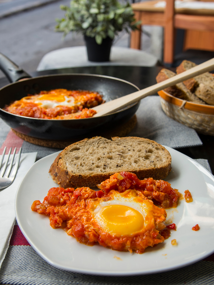 Shakshouka and bread on the table