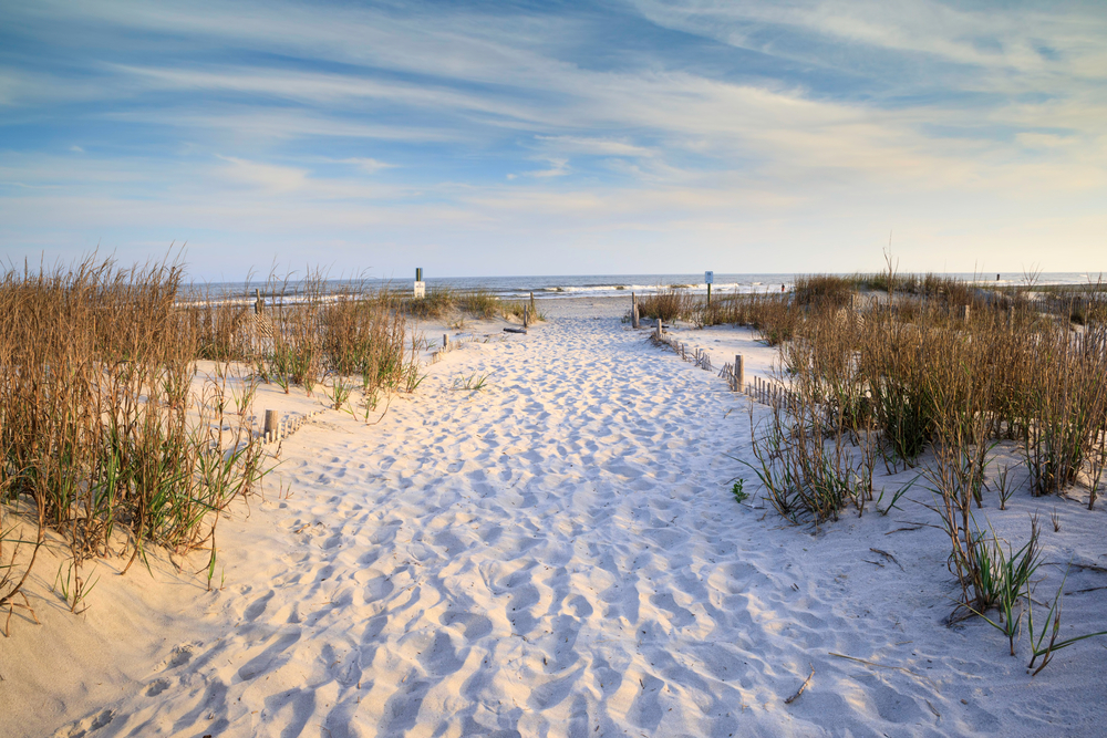 Sandy path with footprints leading to the Atlantic Ocean on Folly Beach