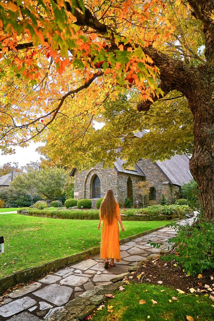 woman walking in front of church at blowing rock one of the mountain towns in north carolina 