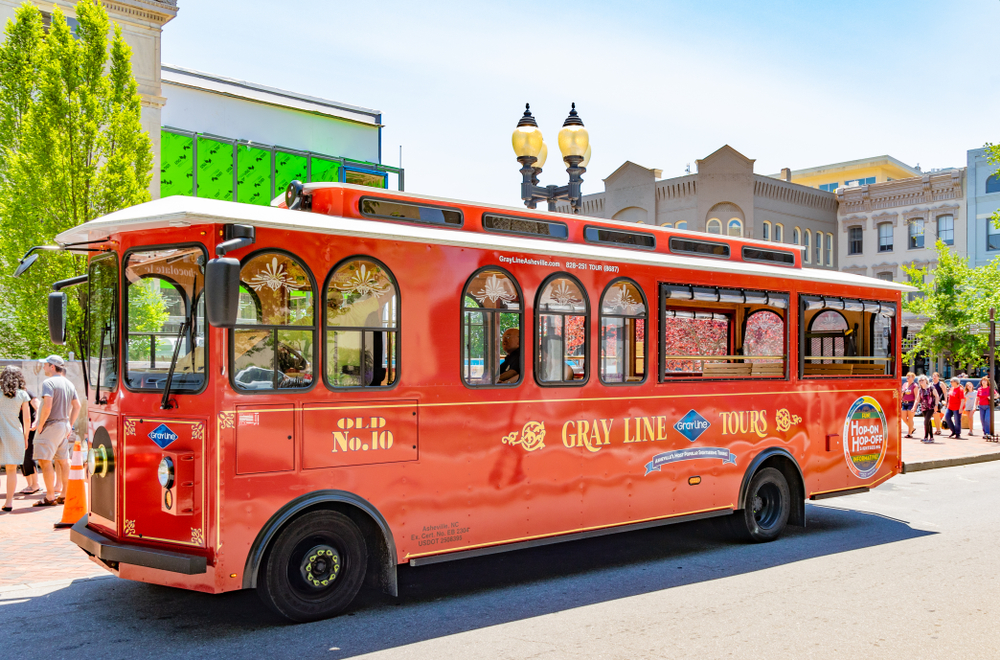 The red Gray Line Trolley parked on the street.