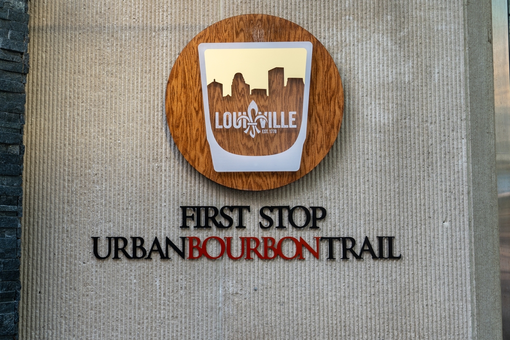 The start of the Kentucky Bourbon Trail sign in red and black letters