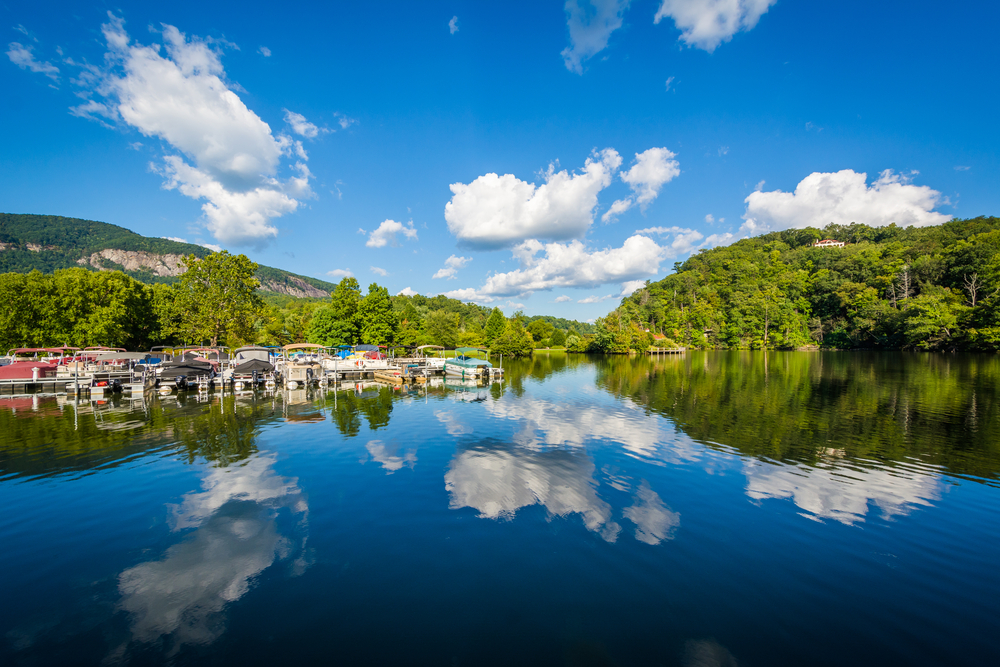 Lake Lure perfectly reflecting the sky and a marina.