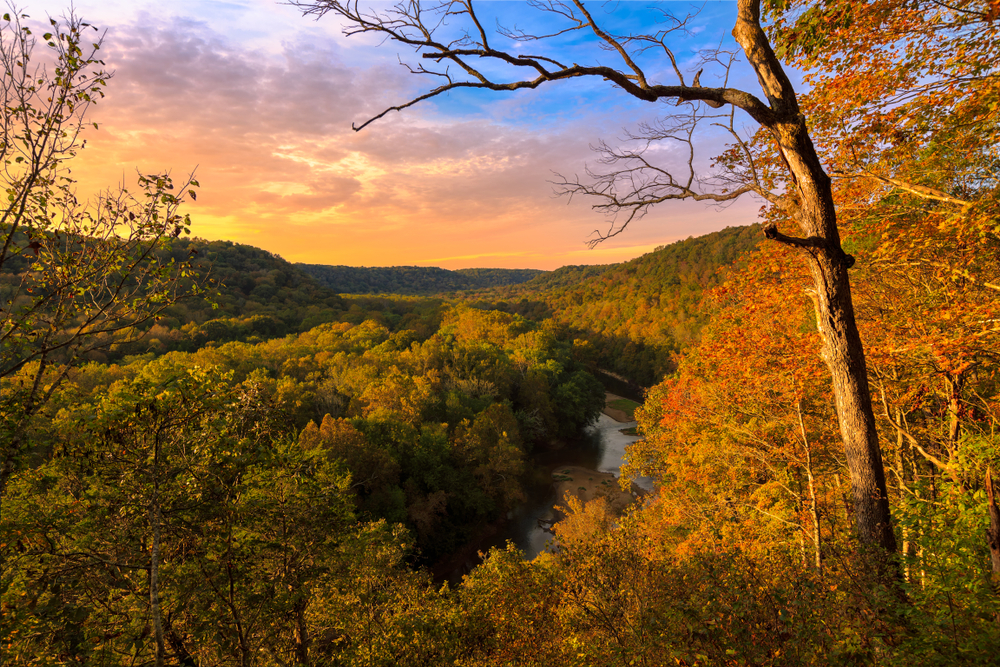 A sunset view over a river valley in the fall.
