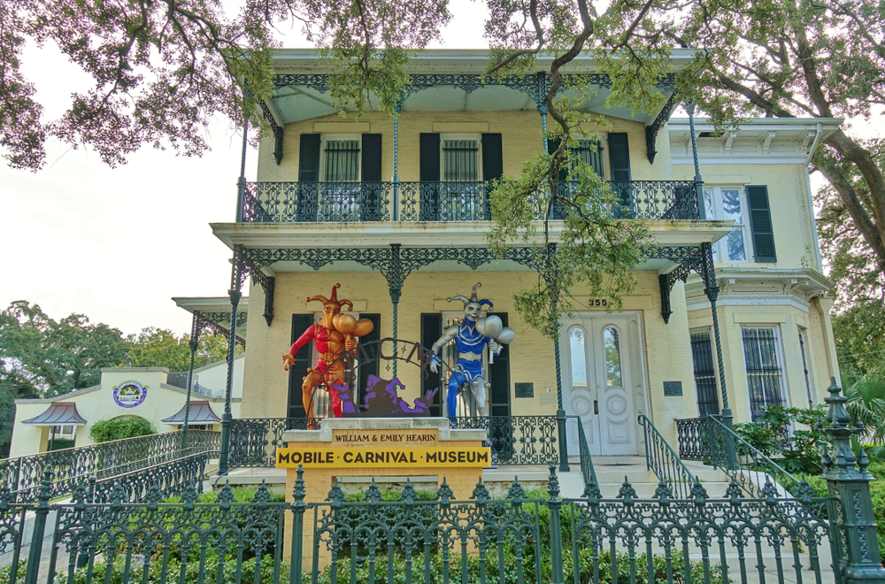 Exterior of the Mobile Carnival Museum with colorful jesters on the sign.