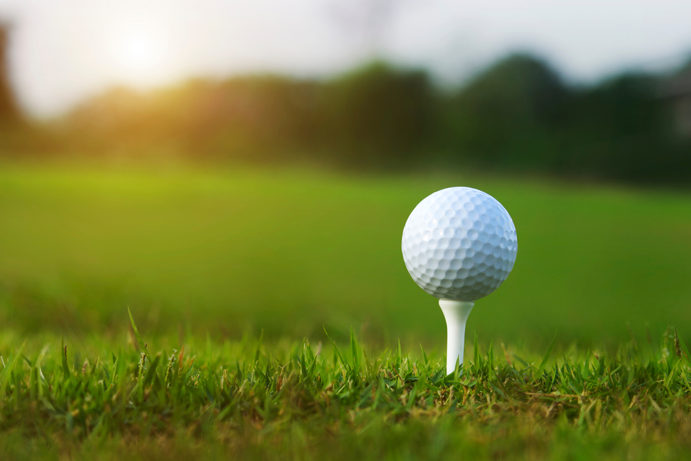 Close up of a golf ball on a tee.