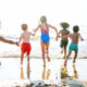 Photo of children running on one of the best beaches in Texas.